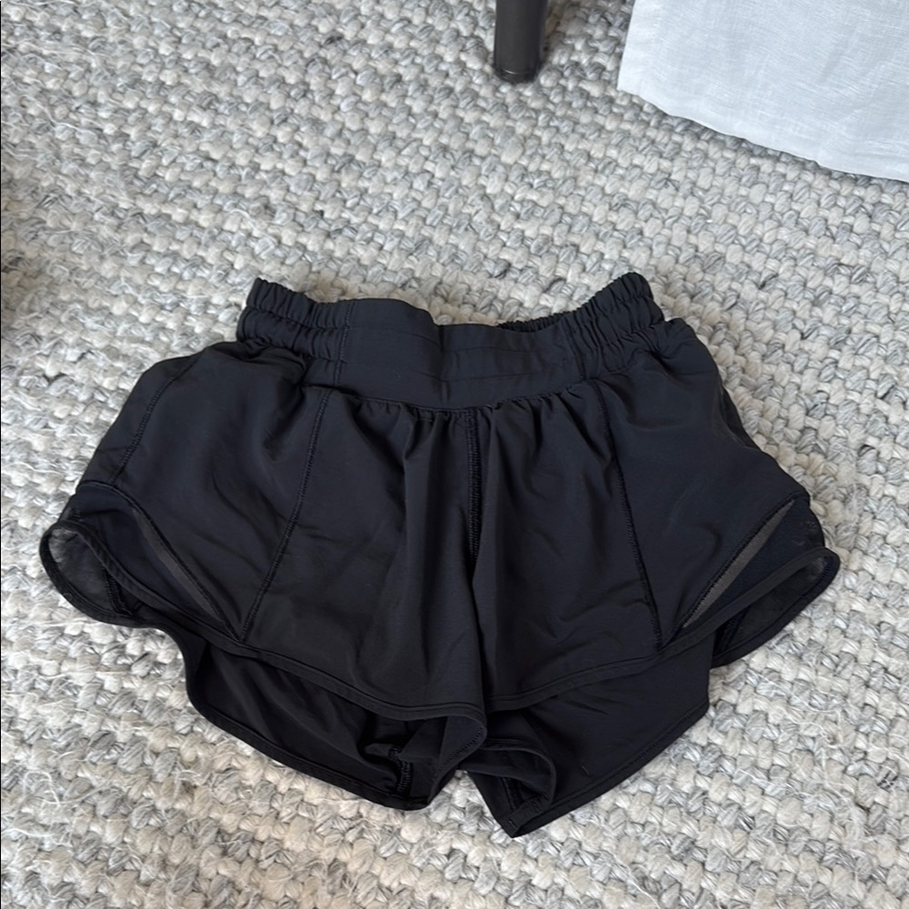 Lululemon black hotty hots. 2.5 inch. Size 0. Worn a lot.